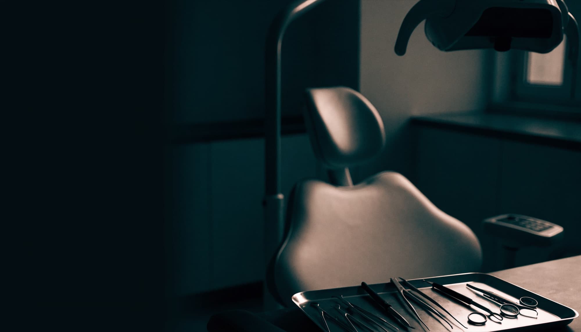 A modern dental operatory at rest in low moody light