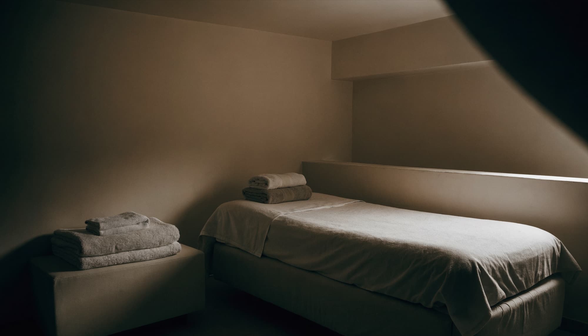 A luxury med spa treatment room at rest in soft indirect light