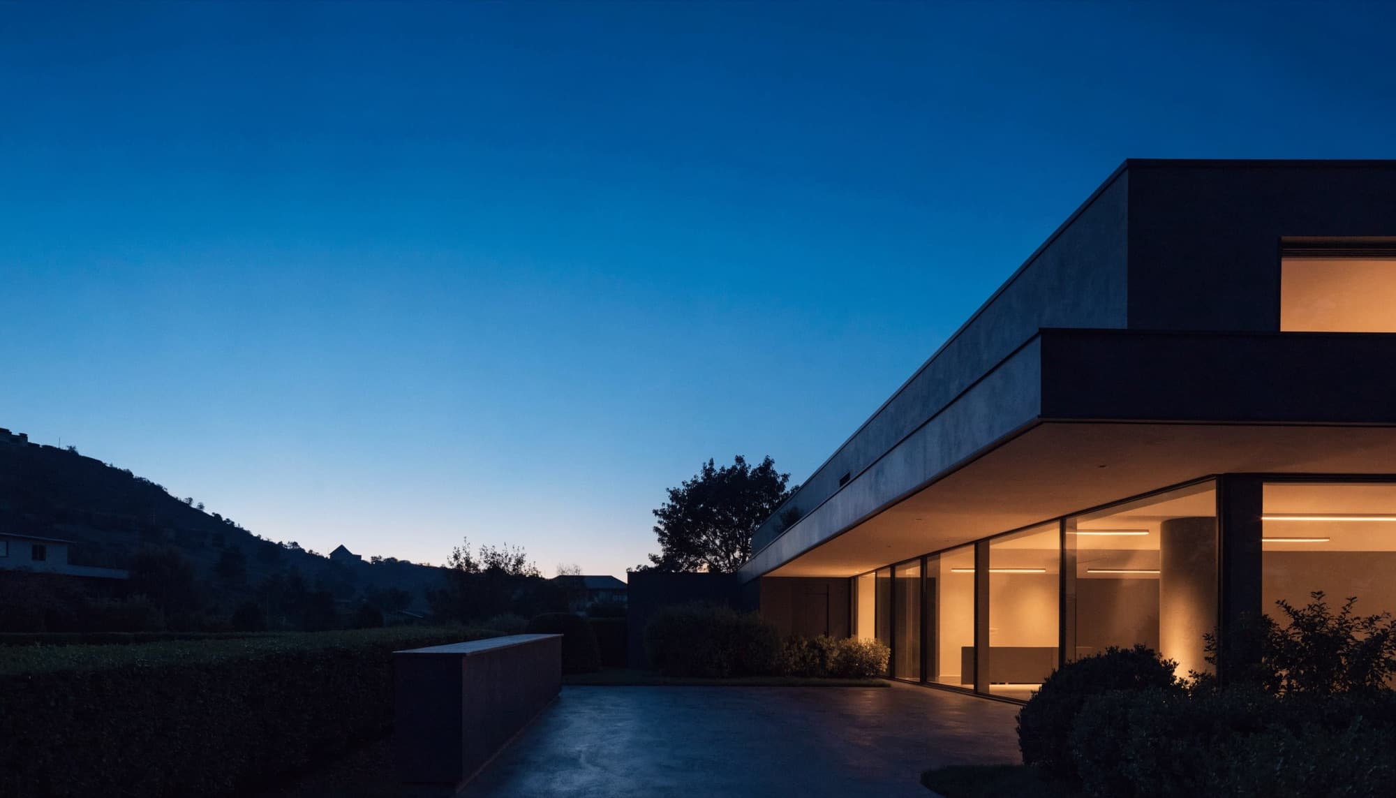 A modern residential property exterior glowing at dusk