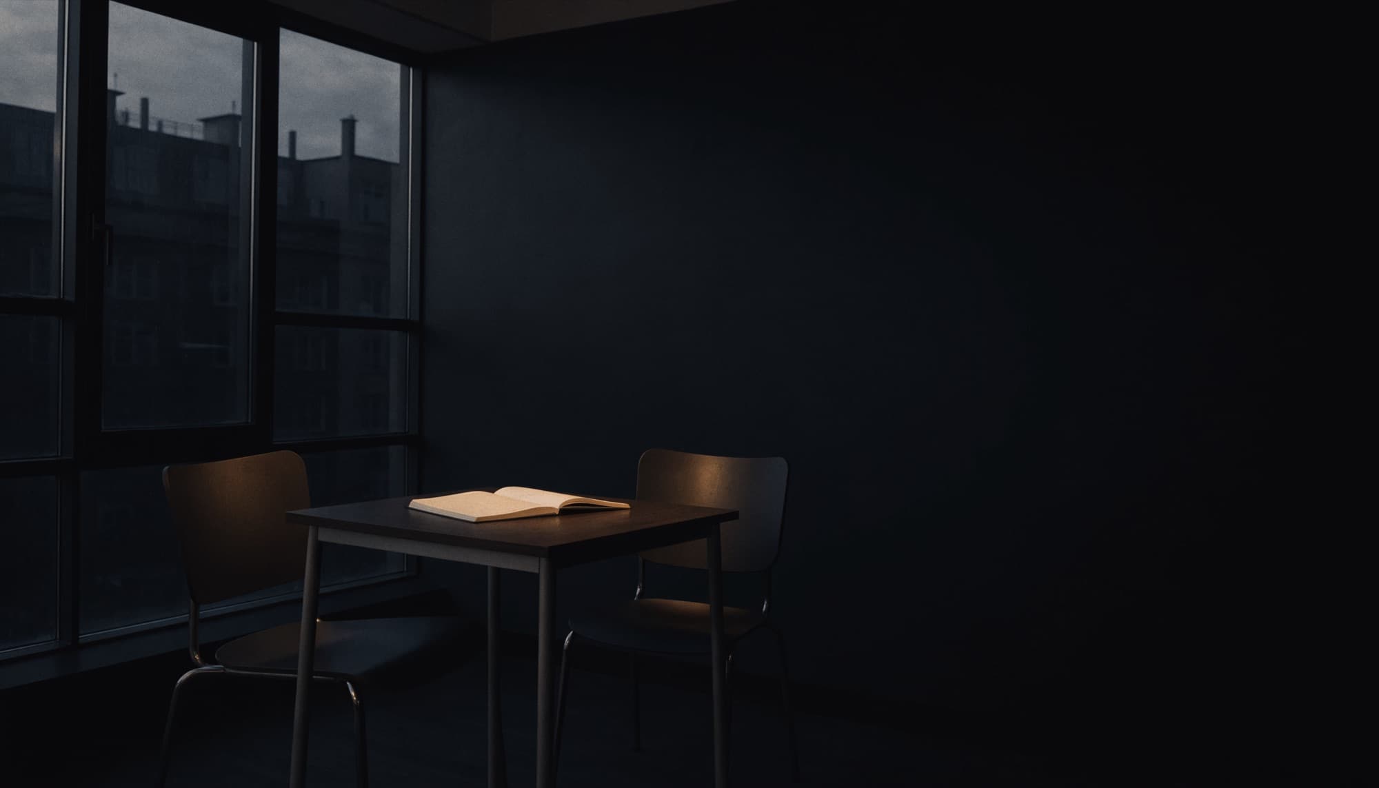 An empty modern interview room at dusk with two chairs and a table